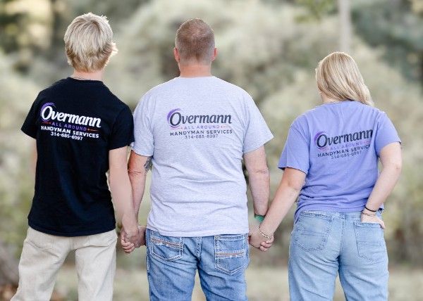 Matt and his family from behind, holding hands, all wearing Overmann All Around shirts