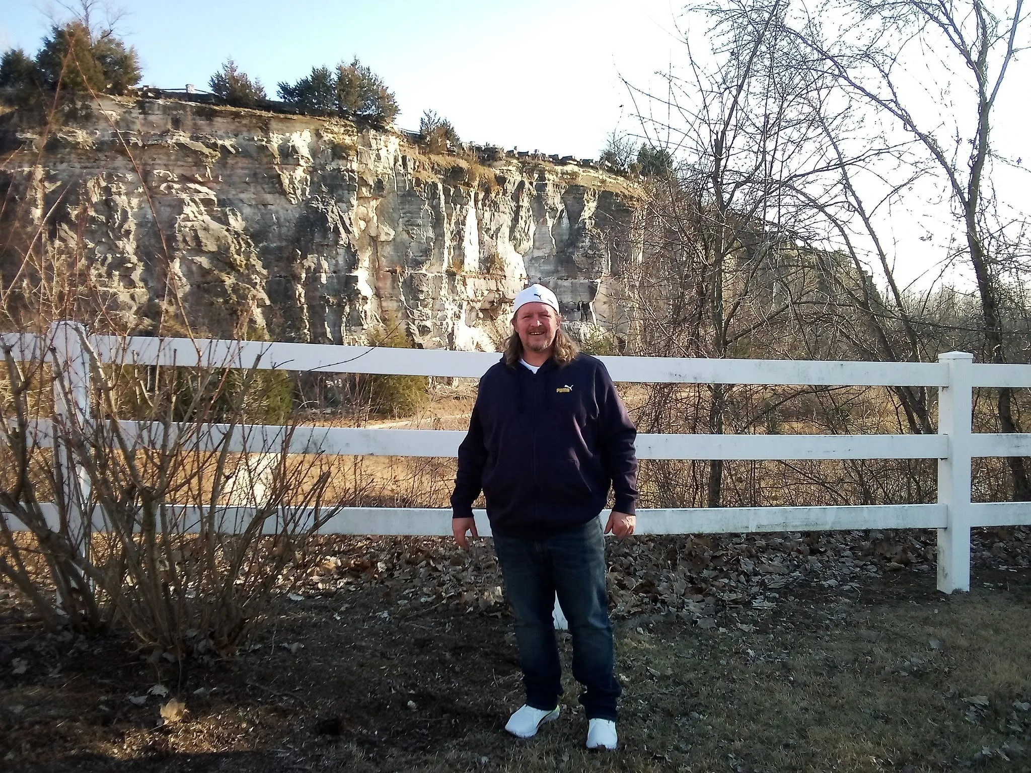 Matt Overmann standing outdoors by a white fence