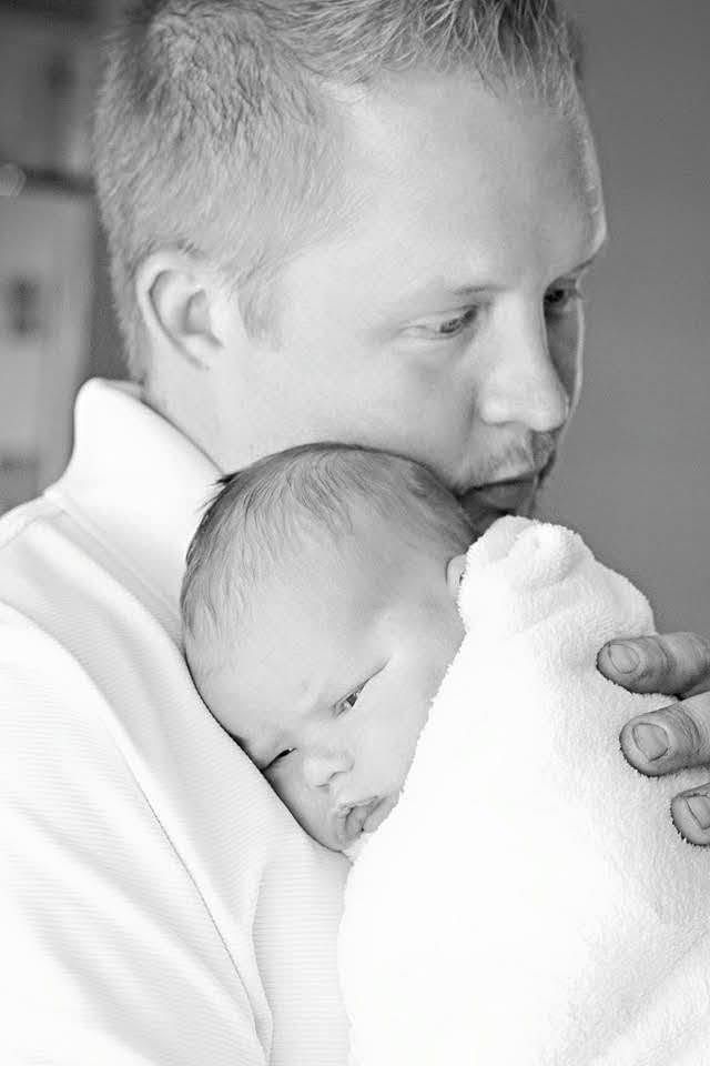 Matt holding his newborn, black and white